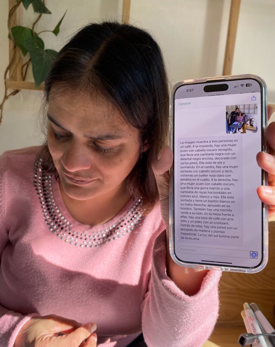 Lucero reading an AI-generated description of a photo aloud from her phone.